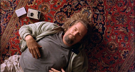 Man listening to music while laying on a Persian Rug